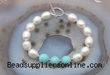 CFB943 Hand-knotted 9mm - 10mm rice white freshwater pearl & blue howlite bracelet