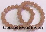 CGB4588 7.5 inches 10mm - 11mm round sunstone beaded bracelets